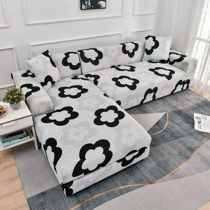 L-shaped sofa protector covers featuring a gray and black floral pattern on a light gray sofa.