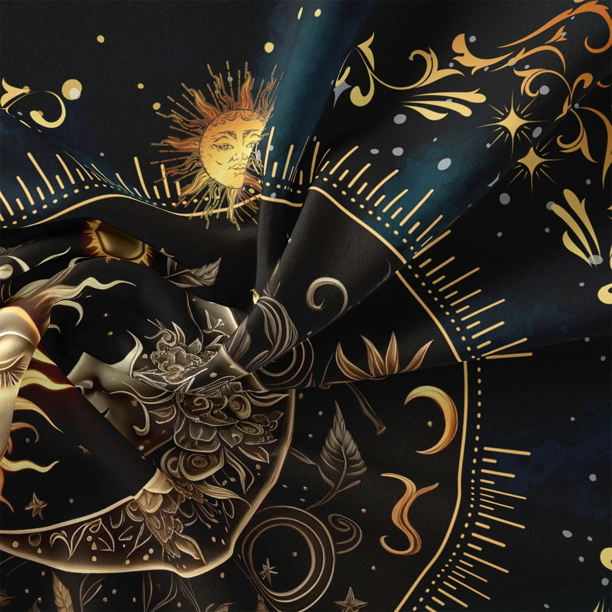 Dark fabric with gold celestial patterns and sun motifs draped in a flowing fabric.