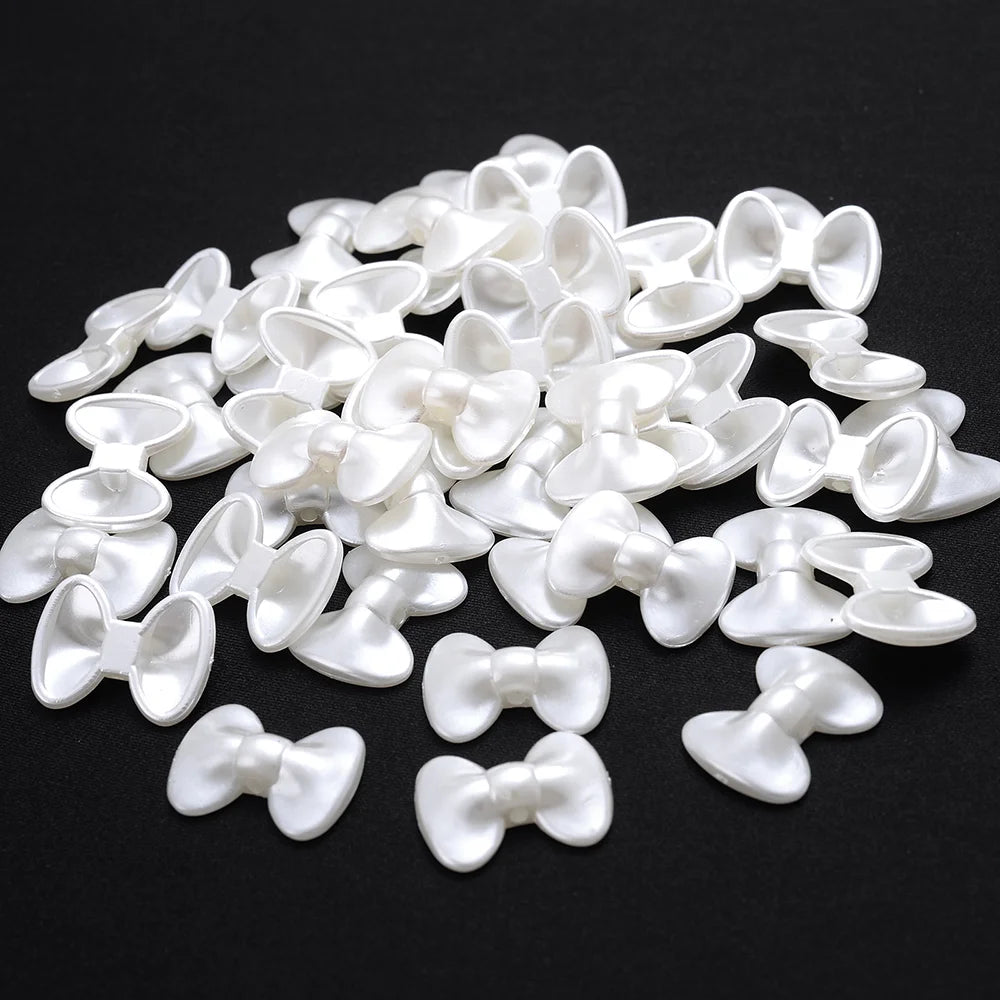 A pile of white imitation pearl flower spacer beads for DIY jewelry.