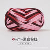A ball of hand-dyed fabric strip yarn in shades of pink and maroon, coiled for crochet or knitting.