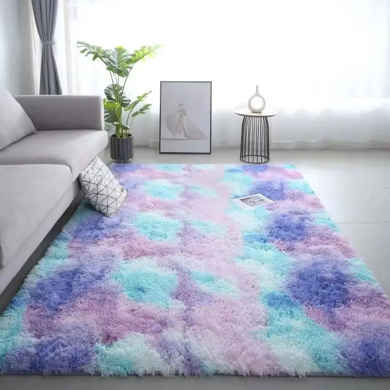 A fluffy tie-dye silk wool rug featuring shades of purple, pink, and blue in a bright living room setting.