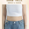 A close-up of a woman wearing blue denim pants with decorative butterfly buttons, demonstrating the effect of the double-side