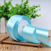 Roll of light blue satin ribbon for gift wrapping and DIY crafts