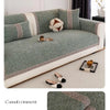 A gray sofa cushion cover with a textured fabric and decorative piping, shown on a light-colored sofa.
