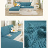 A teal sofa seat protector cushion cover displayed on a sofa in a bright living room setting.
