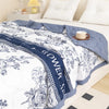 A navy blue floral patterned duvet cover featuring white and blue accents on a bed.