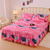 Pink floral bed skirt with blue and purple birds decorating a pink bed.