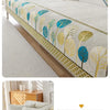 A light beige jacquard sofa seat and back cover featuring a botanical pattern of blue, yellow, and green leaves.