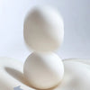 A white memory foam cushion demonstrating lumbar support and pressure relief.