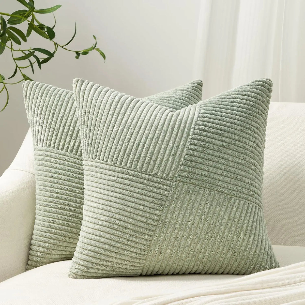 A light sage green textured corduroy throw pillow cover with vertical ribbing.