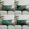 A set of four accent pillows featuring a dark teal background with flowing gold lines and foliage patterns.