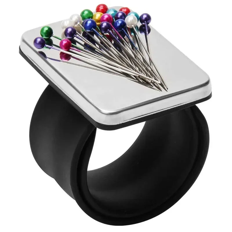 A silver magnetic wrist pincushion filled with colorful pins and a silicone band.
