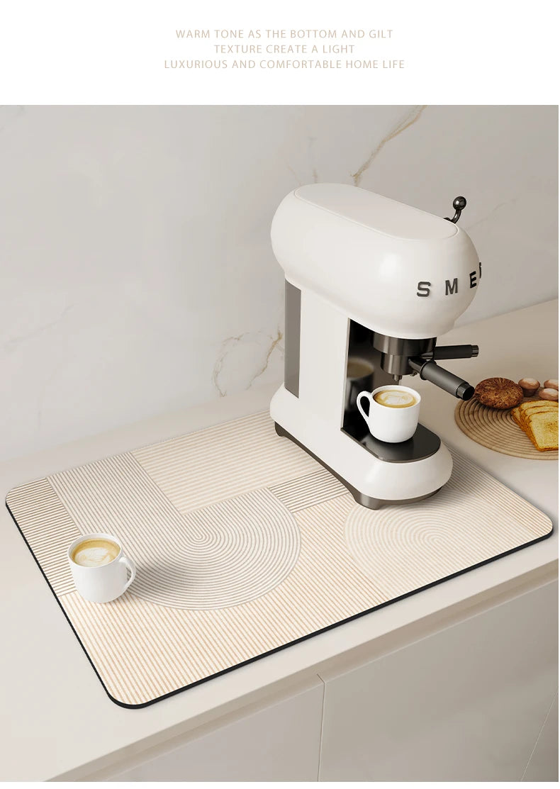 A white electric kitchen drain mat is placed on a light-colored countertop next to a white cup.