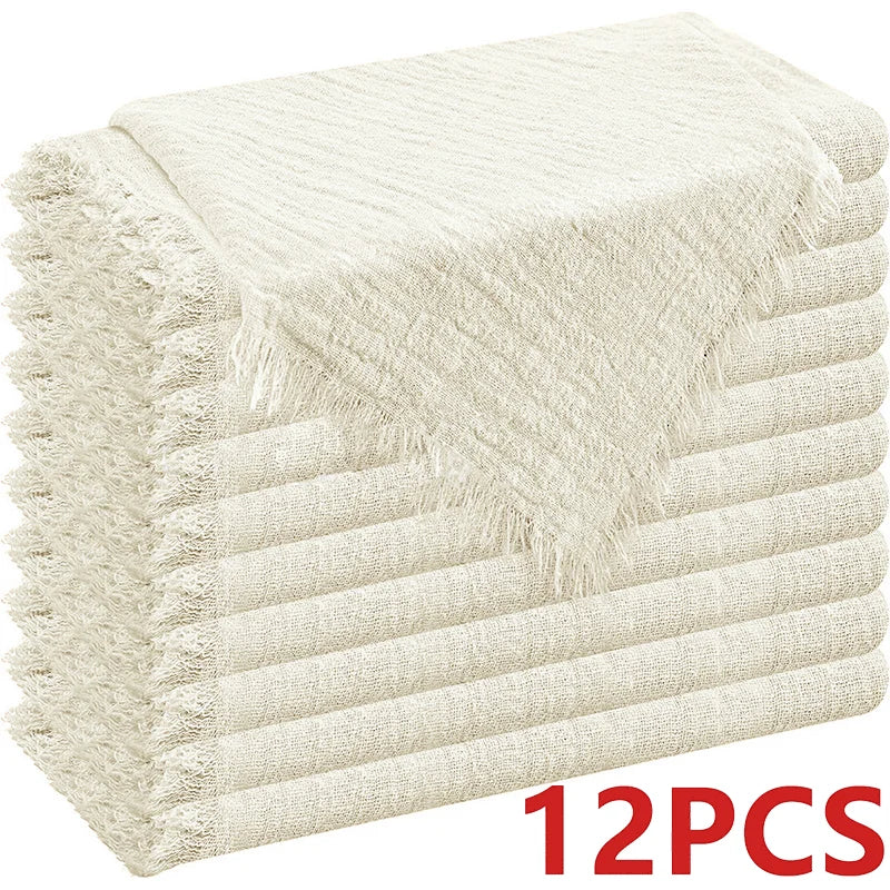 A stack of 12 decorative cloth napkins in a beige or cream color.