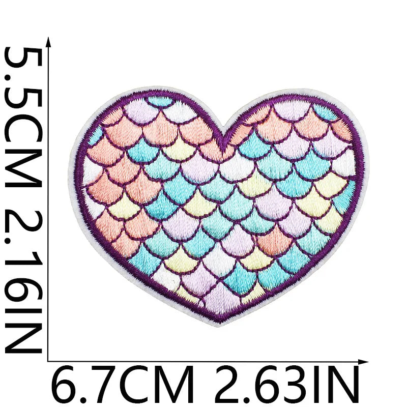 A heart-shaped embroidery patch featuring a scale pattern in pastel pink, peach, and blue hues.