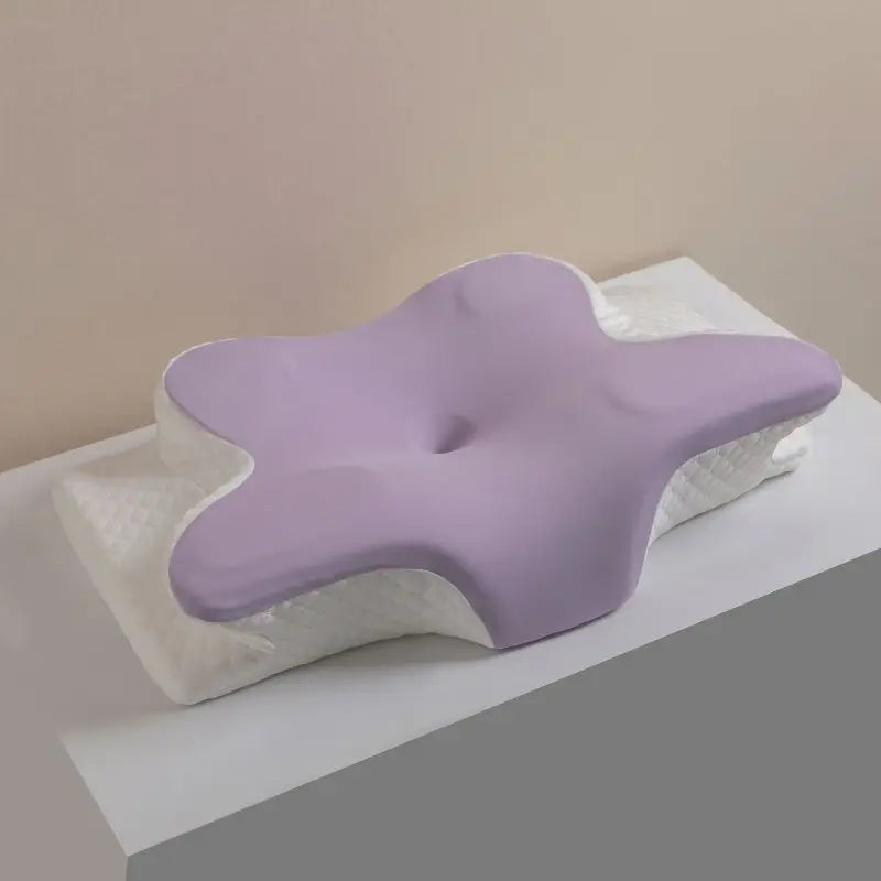 A light purple ergonomic memory foam cervical pillow resting on a white surface.