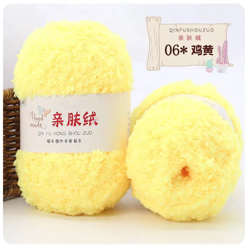 A ball of bright yellow soft coral velvet yarn for crafting displayed next to a label and a wooden stick.