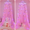 Pink decorative bed curtain mosquito net draped over a bed with stuffed animals