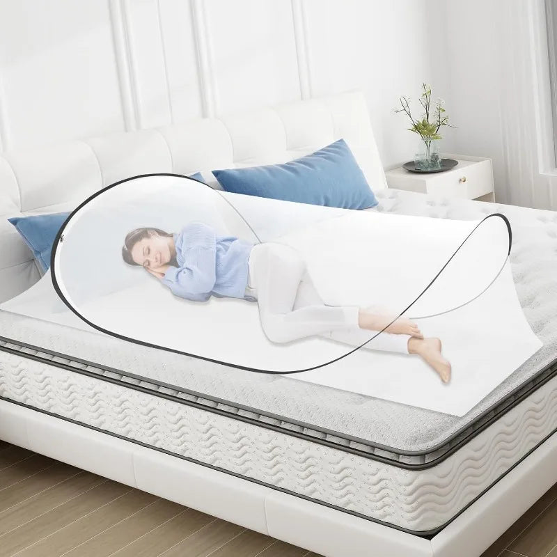 A portable mosquito net pop-up bed is shown on a white bed with a magnifying lens overlay.