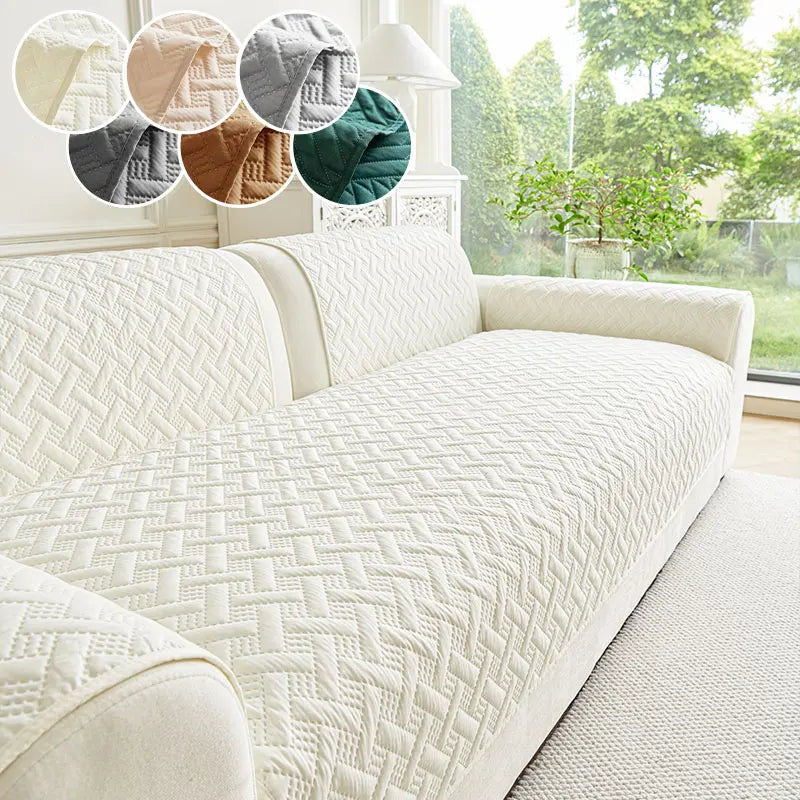 A white quilted sofa cushion displayed on a light-colored sofa with various colored fabric swatches.