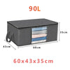 A black foldable storage box with a clear window showing several folded textiles.