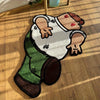 A cartoon rug depicting a person wearing a white shirt and green pants with a brown skin tone.