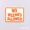 An orange embroidered patch with white text that reads NO WENIES ALLOWED