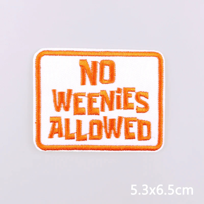 An orange embroidered patch with white text that reads NO WENIES ALLOWED