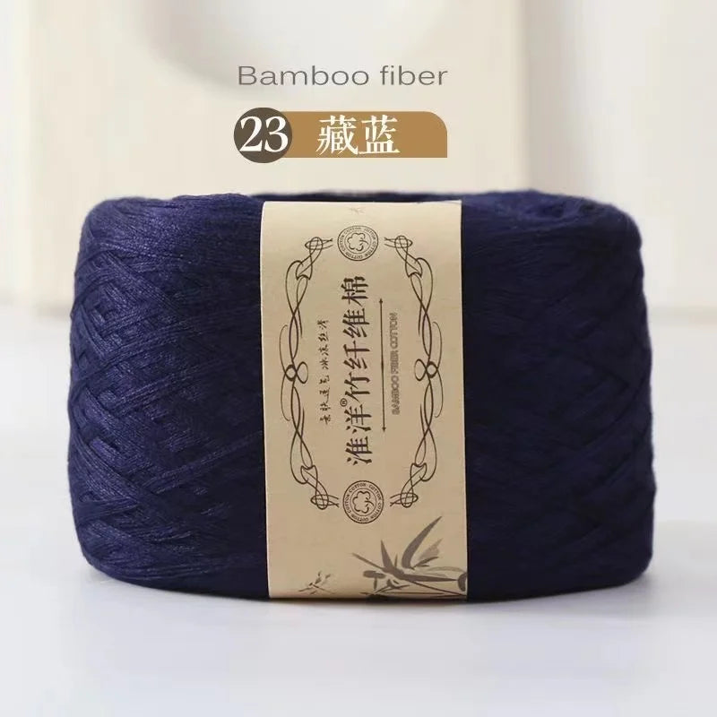 A skein of dark indigo bamboo fiber yarn labeled as Bamboo fiber for crafting.