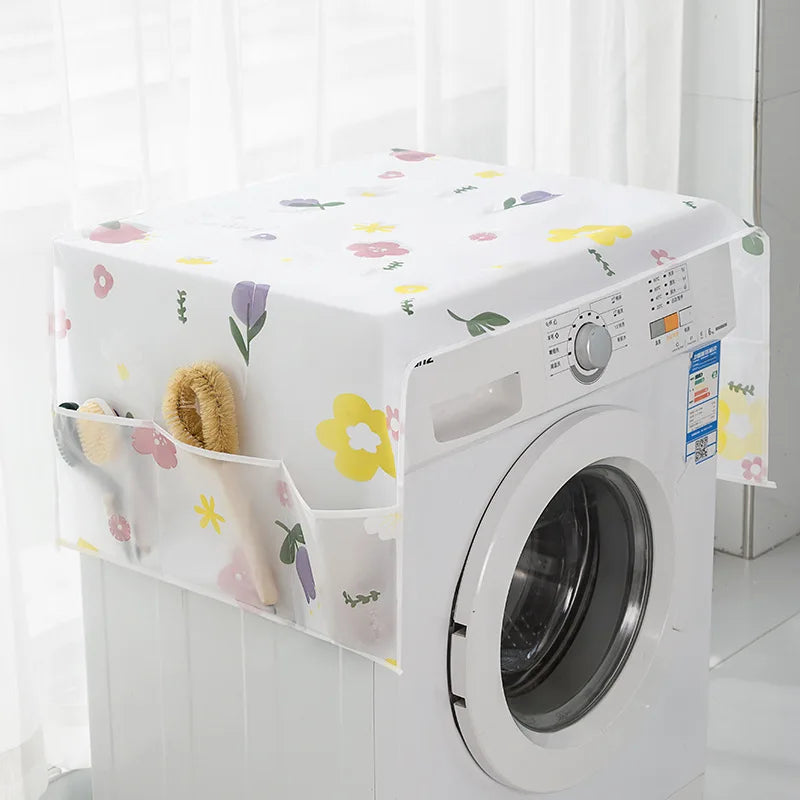 A white washing machine with a floral dust cover placed on a white surface.