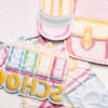A collection of iron-on decorative patches featuring various colors and designs on pink and yellow fabric.