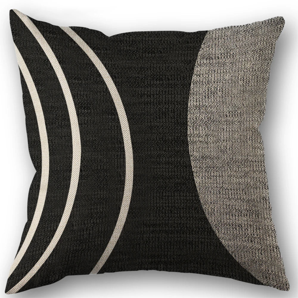 A black and white abstract geometric throw pillow cover with curved stripes.