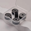 A clear plastic container holds several spools of prewound sewing machine bobbin threads.