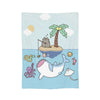 A light blue blanket featuring a cartoon illustration of a cat sleeping on a palm tree with various sea creatures.