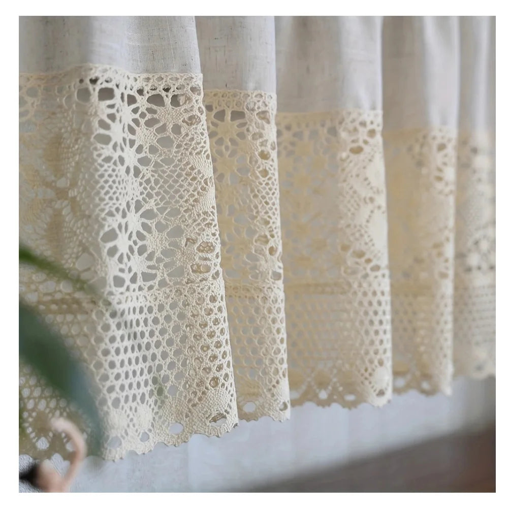 A close-up of a cream colored rustic crochet half curtain with a linen weave texture hanging indoors.