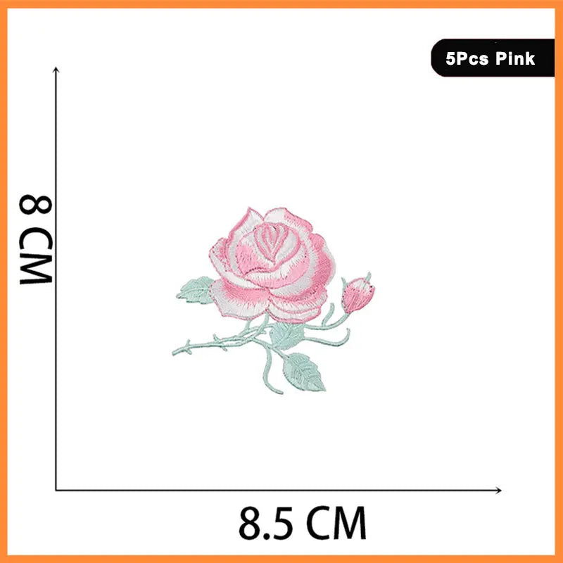 A set of five pink rose and butterfly embroidered iron-on patches.