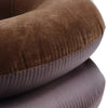 A close-up of a brown inflatable cervical traction neck stretcher pillow.