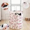 A pink and white foldable canvas laundry basket featuring an elegant bow pattern, shown with close-ups of the fabric detail.