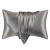 A pair of smooth, gray satin pillowcases folded and displayed against a white background.