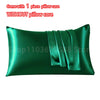 A dark emerald green satin pillowcase with an envelope closure, shown flat.