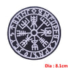 Black embroidered circular patch featuring ancient symbols in white thread