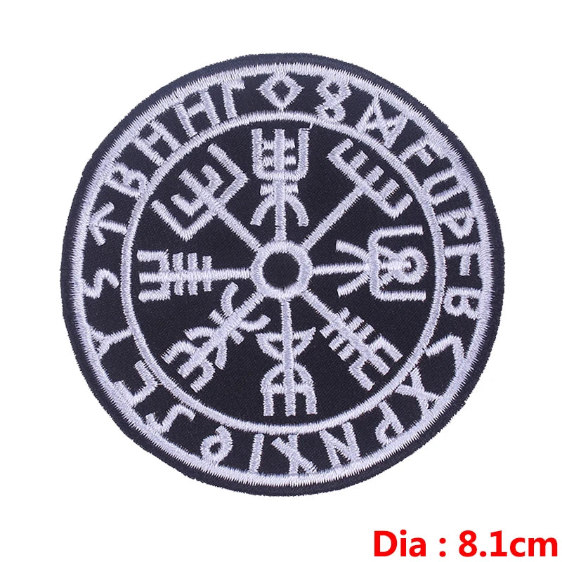 Black embroidered circular patch featuring ancient symbols in white thread