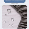 Close-up of a gray fitted bed sheet showing water and dirt resistance with droplets on the fabric.