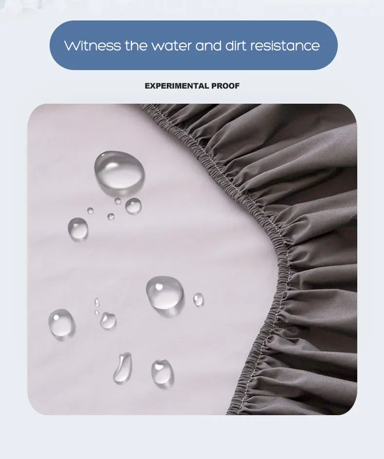 Close-up of a gray fitted bed sheet showing water and dirt resistance with droplets on the fabric.