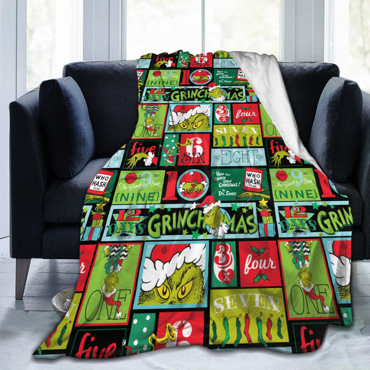 A colorful Christmas themed plush coral fleece throw blanket featuring festive characters and holiday text.