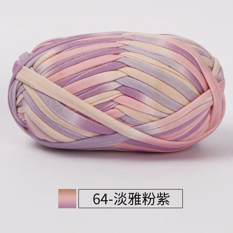 A ball of hand-dyed fabric strip yarn in shades of pink and lavender for crochet and knitting.