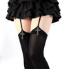 Black gothic lolita suspender socks with silver cross details worn under a ruffled black skirt.