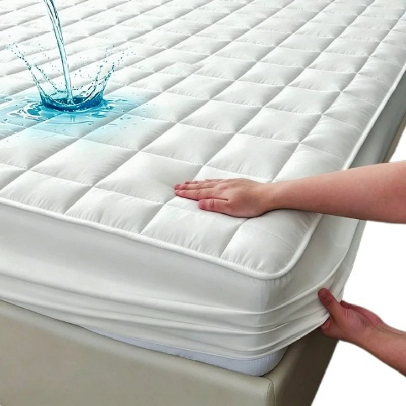 A hand touches a white quilted waterproof mattress protector while water flows onto the surface.
