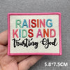 Pink embroidered patch with the text Raising Kids and trusting God on a light background