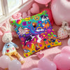 A square pillow cover featuring a vibrant, colorful print with rainbows, flowers, and animals, resting on pink fabric.